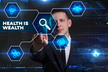 Business, Technology, Internet and network concept. Young businessman working on a virtual blackboard of the future, he sees the inscription: health is wealth