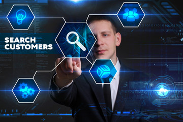 Business, Technology, Internet and network concept. Young businessman working on a virtual blackboard of the future, he sees the inscription: search customers