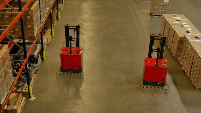 Forked Automatic Guided Vehicles (AGV) pallet truck, unmanned driving through factory hall