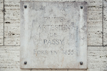 Plaque of the natural source of Passy in the middle of Paris