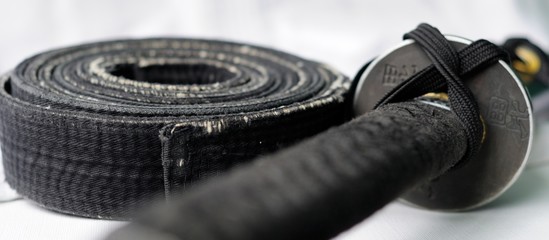 black belt martial arts and sword katana isolated on white background