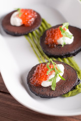 Traditional russian blini with sour cream and red caviar. Selective focus