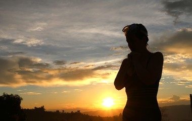Woman at sunset in the middle of the landscape
