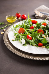 fresh vegetable salad with rucola, tomatos and goat cheese. Healthy food concept. Copy space.