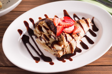 crepe with banana and chocolate and fresh strawberries