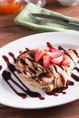 crepe with banana and chocolate and fresh strawberries