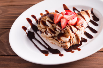 crepe with banana and chocolate and fresh strawberries
