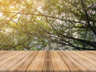 Wooden board empty table in front of blurred background. Perspective brown wood table over blur trees in forest background - can be used mock up for display or montage your products. spring season.