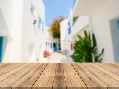 Wooden board empty table in front of blurred hotel building background. Perspective brown wood over blur hotel - can be used for display or montage your products.Mock up for display of product.