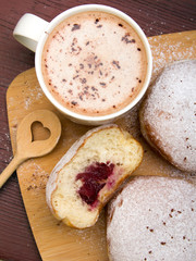 Classic donuts with powdered sugar, on wooden background