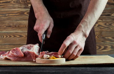 Butcher cutting pork meat