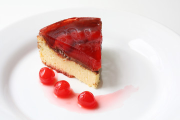 isolated on white served slice of delicious cherry cheese cake with cherry topping