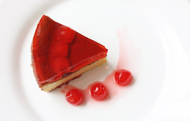 isolated on white served slice of delicious cherry cheese cake with cherry topping