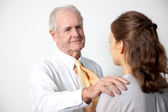 Daughter Adjusting Tie To Father