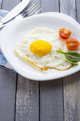 Food fried egg spinach salad wood background
