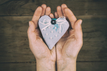 Heart from cloth on wood desk