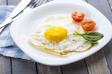 Food fried egg spinach salad wood background
