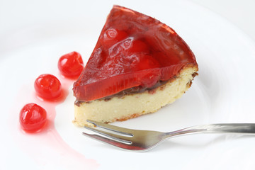 isolated on white served slice of delicious cherry cheese cake with cherry topping