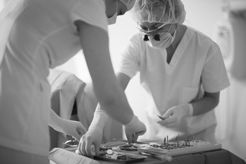 Dentist and his assistant collect tool kit for working