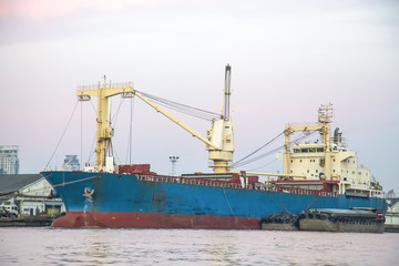 .Cargo ship docking port And a small cargo ship moored vessels. In order to unload the ship. The ship was sold to a foreign country.