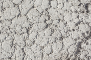 White arid cracked dry textured desert terrain