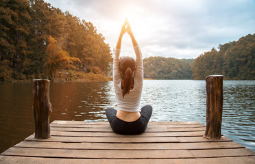 Woman do yoga outdoor. Woman exercising yoga at the nature background, select focus
