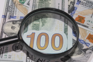 Dollar under magnifying glass