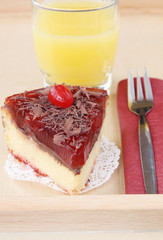 served romantic breakfast for lover: glass of orange juice and delicious cherry cheese cake