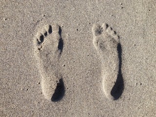 Fototapeta na wymiar Impronte nella Sabbia