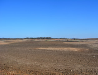 beautiful spring landscape: vsphannoe field on a background of blue sky, agriculture, earth, nature, countryside 