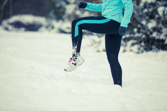 Running lady legs, sporty clothes, winter fitness