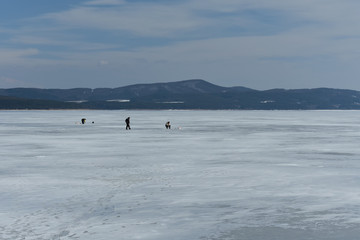 Fishermen on an icy lake