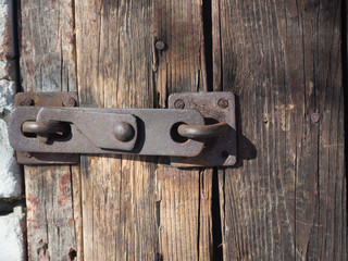 Old lock on the door. lock on the door of an old farmhouse . true village style . close-up. focus on lock