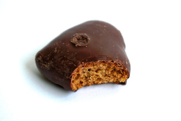 Chocolate heart with a bite mark on a white background