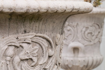 Stone flower pots decorated with raised flowers
