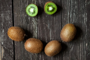 Fototapeta na wymiar smiling kiwi sliced and whole fruits.