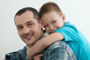 Fototapeta premium Happy father and son playing and laughing together at home.