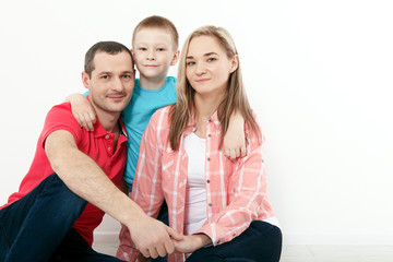 Obraz premium happy family mother and father playing with baby at home