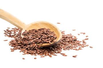Wooden spoon with linseeds or flax seeds isolated on white
