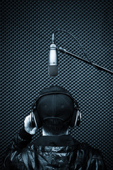 back of male singer singing in recording studio