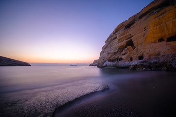 Panorama of Matala beach with the caves on the rocks that were used as a roman cemetery and at the decade of 70's were living hippies from all over the world, Crete, Greece