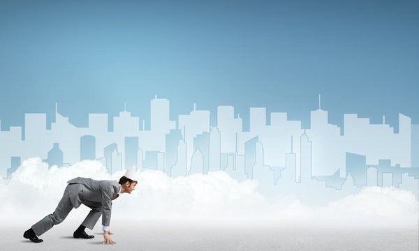 King businessman in elegant suit running and blue cityscape silhouette at background