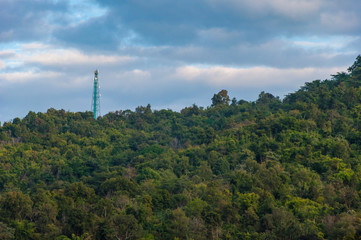 Fototapeta na wymiar Telecom Tower on the mountain with blue sky background