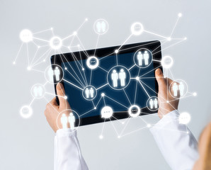 Close of female doctor hands working with tablet pc computer