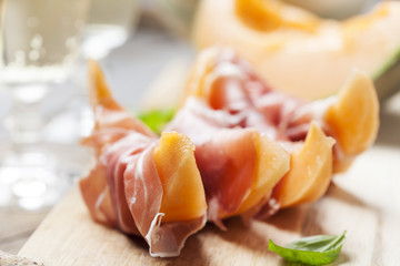 Slices of cantaloupe melon and prosciutto ham, shallow DOF