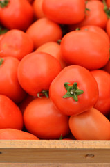 Stack of tomatoes in basket for sale