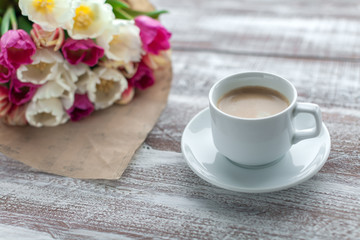 tulips and coffees isolated on a wooden table