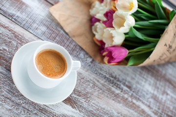 tulips and coffees isolated on a wooden table