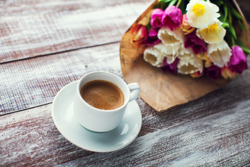 tulips and coffees isolated on a wooden table