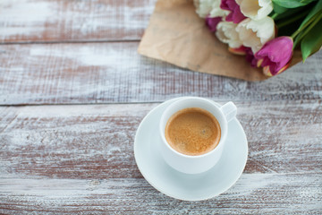tulips and coffees isolated on a wooden table